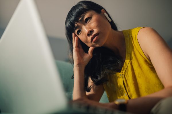 focused-asian-woman-working-on-her-laptop-while-solving-a-problem.jpg
